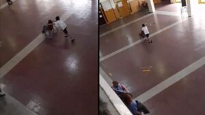 Bambino aiuta il suo compagno di classe sulla sedia a rotelle durante la lezione di educazione fisica